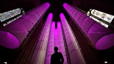 Artist Peter Walker stands in front of his installation Identity - We Are All Together at the Anglican Cathedral in Liverpool. Reuters