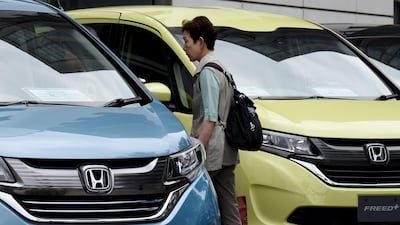 Hondas in front of the company headquarters in Tokyo. The firm has posted a rise in profits. AFP