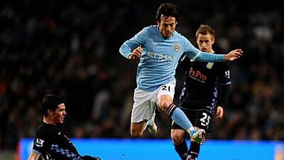 Manchester City's David Silva hurdles the tackle of Ciaran Clark during their 3-0 win against Aston Villa.
