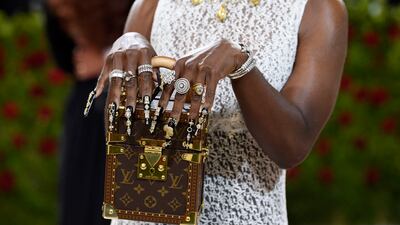 Cynthia Erivo shows off her purse, bling and fingernails. AP