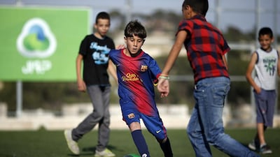 Palestinian Lionel Messi lookalike Ahmad Salaymah playing football. Thomas Coex / AFP