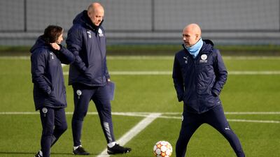 Manchester City manager Pep Guardiola juggles the ball during training for the Sporting match. AFP
