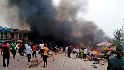 Smoke rises after a bomb blast at a bus terminal in Nigeria's central city of Jos on May 20, 2014. Two explosions ripped through a bustling bus terminal and market frequented by thousands of people. Stefanos Foundation / AP Photo