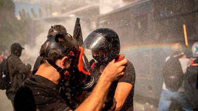 Police use a water cannon against the protesters. AFP