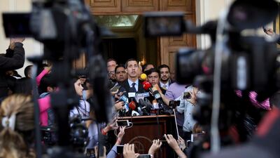 Juan Guaido, who has declared himself interim president of Venezuela, speaks with the media outside the National Assembly in Caracas. AP
