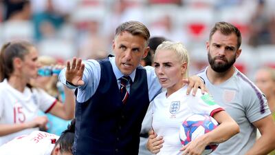 Phil Neville, pictured with Alex Greenwood, has stepped down as manager of England's women with immediate effect. PA