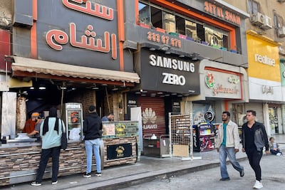 Customers wait for their orders at a Syrian restaurant in the Sixth of October suburb of Cairo. AFP
