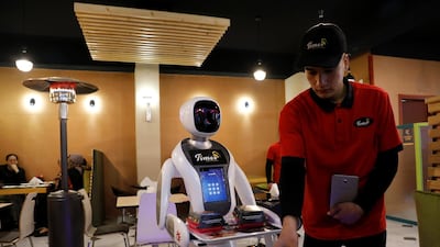 Timea brings food to a table at the Times Fast Food restaurant in Kabul, Afghanistan. Reuters