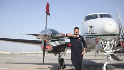 Captain Brendon Allen, of the National Centre of Meteorology and Seismology, with the Beechcraft cloud-seeding aircraft. Lee Hoagland / The National