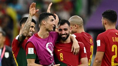 Portugal's Cristiano Ronaldo and Bruno Fernandes celebrate after their 2-0 win in the World Cup Group H game against Uruguay at Lusail Stadium on November 28, 2022. Reuters