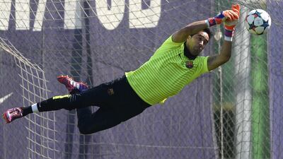 One for the cameras from Barcelona goalkeeper Claudio Bravo, who makes a save during training. Manu Fernandez / AP Photo