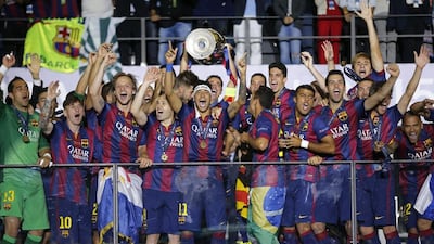 Barcelona players celebrate with the trophy after the Champions League final soccer match between Juventus Turin and FC Barcelona at the Olympic stadium in Berlin Saturday, June 6, 2015. Barcelona won the match 3-1. (AP Photo/Frank Augstein)