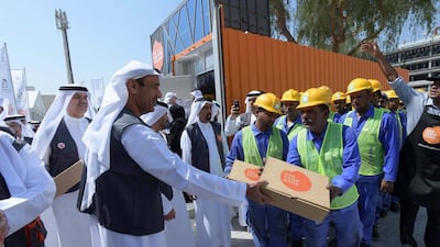 Food is handed out to workers on World Food Day. Dubai Municipality