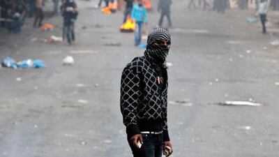 A Palestinian protester holds stones during clashes with Israeli soldiers in the West Bank city of Hebron on Monday following the funeral of Arafat Jaradat. Ammar Awad / Reuters