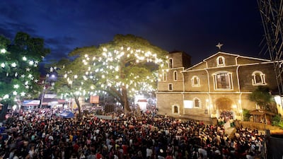 Catholics attend the traditional Misa de Gallo (Dawn Mass) in front of a church in Las Pinas City, south of Manila, Philippines. EPA