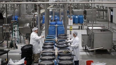 Workers manage barrels of chili paste at the Huy Fong Foods Sriracha Hot Chili Sauce factory. David McNew / Getty Images / AFP