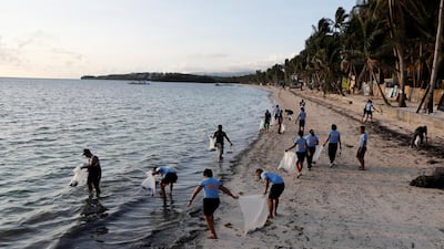 Policemen collect trash at Bulabog beach in the holiday island of Boracay during the first day of a temporary closure for tourists, on April 26, 2018. Erik De Castro / Reuters