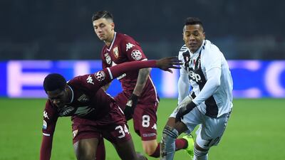 Juventus full-back Alex Sandro in action with Torino's Ola Aina and Daniele Baselli. Reuters