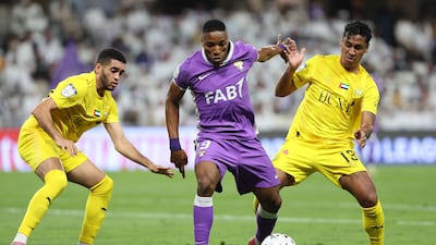 Kodjo Laba of Al Ain battles with Gabriel Vareta, left, and Renato Tapia of Al Wasl