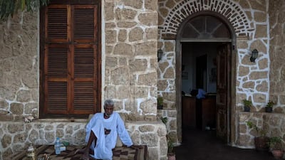 A man rests outside the hotel's arched stone entrance. Photo: El Quseir Hotel