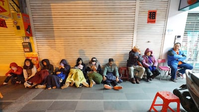 Costumers escaped from the damaged Marshal Hotel sit outside. A hotel on the east coast of Taiwan has collapsed after a 6.4-magnitude earthquake, the government said. Yang Jen-Fu / AFP