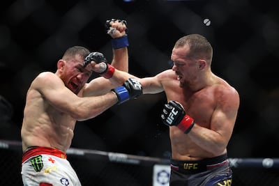Petr Yan, right, and Merab Dvalishvili were awarded Fight of the Night for their epic encounter at UFC 333. Chris Whiteoak / The National