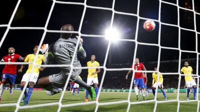 Eduardo Vargas of Chile, unseen, scores the team’s first goal on Thursday night in their 2018 World Cup qualifying win over Brazil. Ivan Alvarado / Reuters