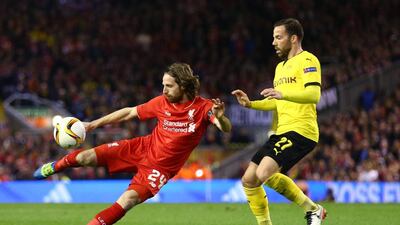 Joe Allen of Liverpool shoots with Gonzalo Castro of Borussia Dortmund. Clive Brunskill / Getty Images