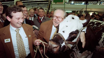 French far-right Front National president and candidate for the presidential election Jean-Marie Le Pen hugs a cow during his visit at the Paris International Agricultural Fair on February 28, 1995. AFP