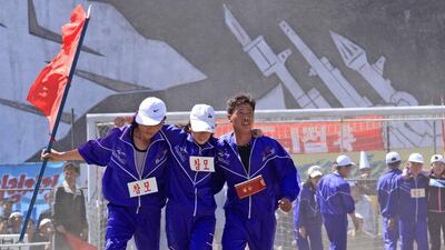 North Korean workers, with their legs tied together, take part in a May Day competition at the Pyongyang Thermal Power Complex. Jon Chol Jin / AP Photo