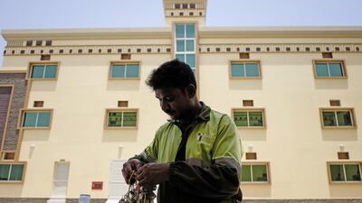 A watchmen sorts through his stock of keys outside one of the labour accommodation buildings in the Al Hail area of Fujairah. Antonie Robertson / The National
