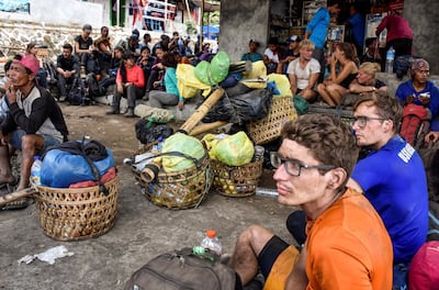 Climbers who managed to descend from Mount Rinjani wait at Sembalun village in Lombok Timur, Indonesia, on July 29, 2018. Antara Foto / Ahmad Subaidi via Reuters
