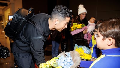 Cristiano Ronaldo receives flowers upon his arrival in Riyadh.