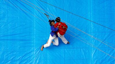 Wrestlers fight during an amateur match inside a improvised ring in Kolkata, India. Reuters