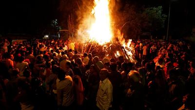 Hindu devotees walk around a bonfire during a ritual known as 'Holika Dahan' which is part of Holi festival celebrations in Ahmedabad. Amit Dave / Reuters
