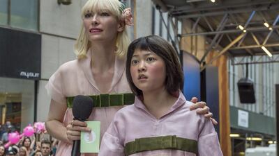 Tilda Swinton as Lucy Mirando, left, and Seo-Hyun Ahn as Mija in a scene from Okja. Barry Wetcher/Netflix via AP