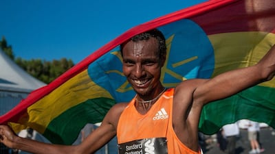 Lemi Berhanu Hayle shown with the Ethiopian flag after his win in the 2015 Dubai Marathon on Friday. Stephen Hindley / AP