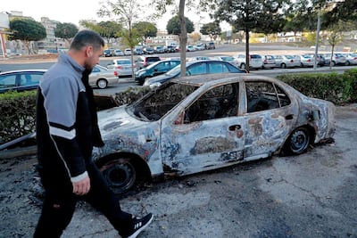 Destroyed cars are pictured in central Beirut a day after young supporters of the country's two main Shiite parties tried to attack a anti-government protest camp in central Beirut. AFP