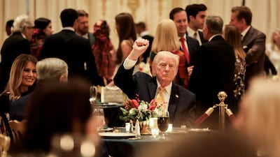 US President Donald Trump, first lady Melania Trump and Viktor Knavs, Mrs Trump's father, attend a Christmas Eve dinner in the ballroom of the President's Mar-a-Lago club in Palm Beach, Florida. Reuters