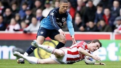 Stoke's Dean Whitehead, bottom, keeps the ball from Arsenal's Kieran Gibbs on April 28, 2012, during their English Premier League soccer match at Britannia Stadium, Stoke, England. Jon Super / Associated Press