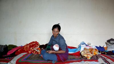 Tsewang Lhadon, 36, a housewife, poses for a photograph in Choklamsar. When asked how living in the world's fastest growing major economy had affected life, she replied, "The children get a better education and are eating more nutritious food because of the government subsidies".