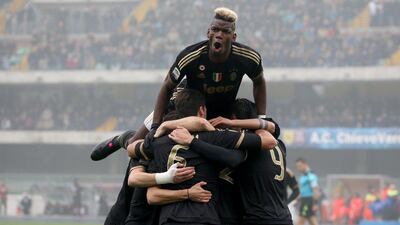 Juventus' Paul Pogba, top, celebrates with teammate Alvaro Morata, unseen, after his goal against Chievo Verona on Sunday in Serie A. Filippo Venezia / EPA / January 31, 2016