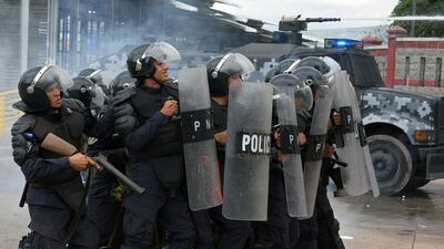 Security forces clash with students from the National Autonomous University of Honduras (UNAH), during a protest in Tegucigalpa. Orlando Sierra / AFP Photo