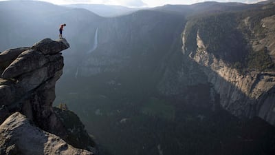 Alex Honnold peers over the edge of Glacier Point in Yosemite National Park after climbing 2000 feet up from the valley floor. National Geographic / Jimmy Chin.