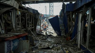 Workers clear a site destroyed by a Russian military strike, Dnipro, Ukraine. Reuters