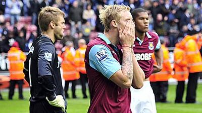 West Ham United's Robert Green, left, Jack Collison, centre, and Jordan Spence, right, cannot hide their despair after defeat to Wigan Athletic on Sunday sealed relegation from the Premier League.