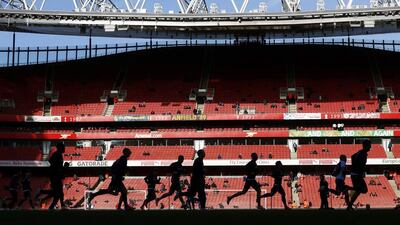Stoke City players warm up before the start of their Premier League match against Arsenal at the Emirates Stadium on Sunday. Eddie Keogh / Reuters