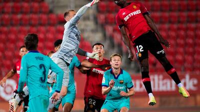 Mallorca midfielder Iddrisu Baba (R) heads the ball in front of Barcelona goalkeeper Marc-Andre Ter Stegen. AFP