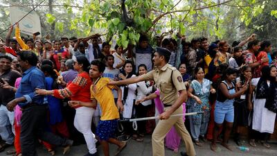 A mourner is pushed by a policeman. Danish Siddiqui / Reuters