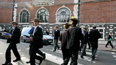 Students from Harrow school cross the road betwen classes on September in London. Getty